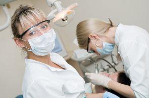 Dentist and dental assistant with a patient. 