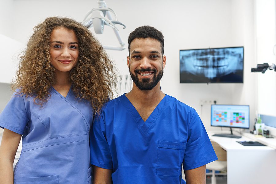 portrait of two young dental assistants standing in dental office 