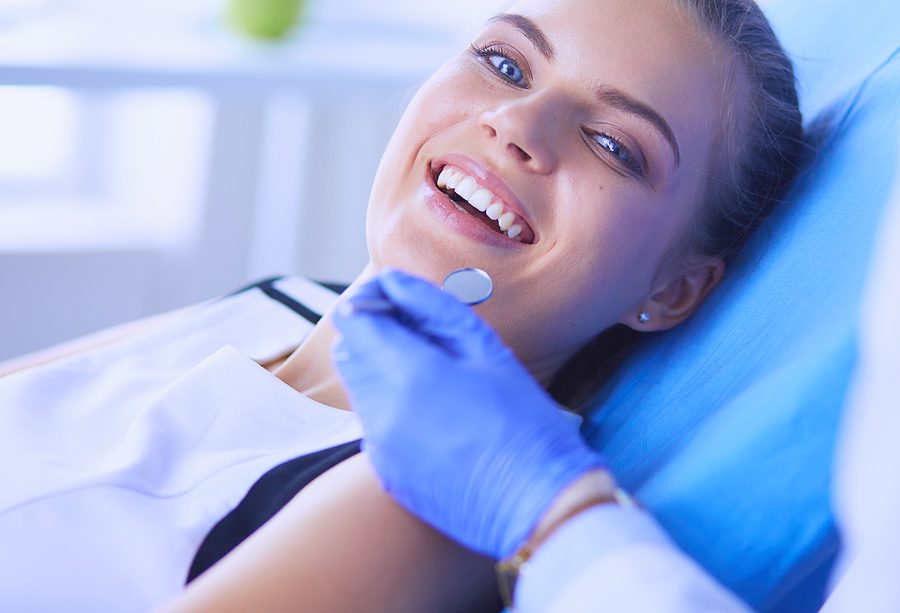 Young Female patient with pretty smile at dentist office.